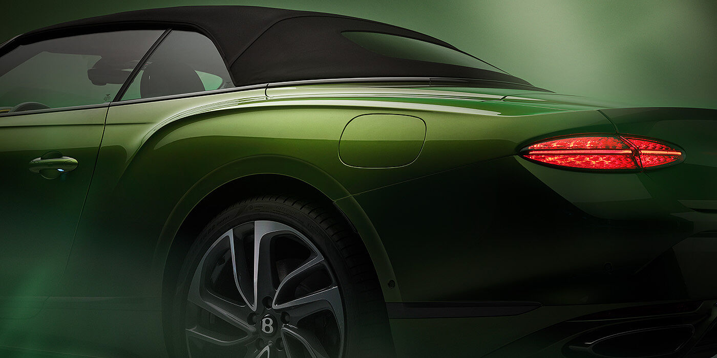 Bentley Vilnius Bentley New Continental GTC Speed rear haunch and tail lamp in Tourmaline Green paint and dark tint brightware with black hood up and illuminated head lamps