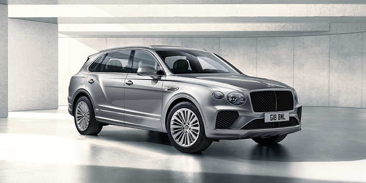 Bentley Vilnius Bentley Bentayga Extended Wheelbase SUV front three quarter in Moonbeam paint with a grey background