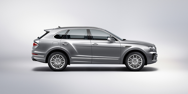 Bentley Vilnius Bentley Bentayga SUV side profile in Moonbeam silver paint against white background featuring 21 inch 5 spoke wheels