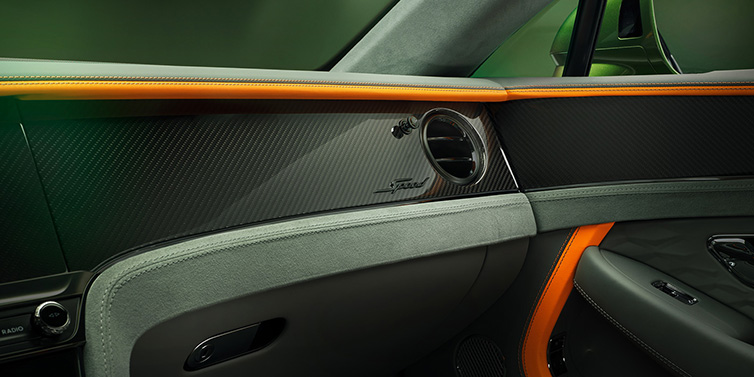 Bentley Vilnius Bentley Continental GT Speed coupe front interior dash detail with high gloss carbon fibre veneer surrounded by Mandarin by Mulliner and Gravity Grey hides