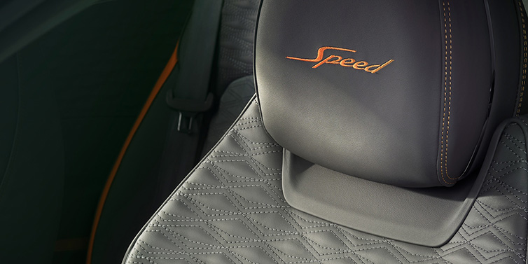 Bentley Vilnius Bentley Continental GT Speed coupe seat detail in Gravity Grey hide and Speed emblem in Mandarin by Mulliner coloured embroidery